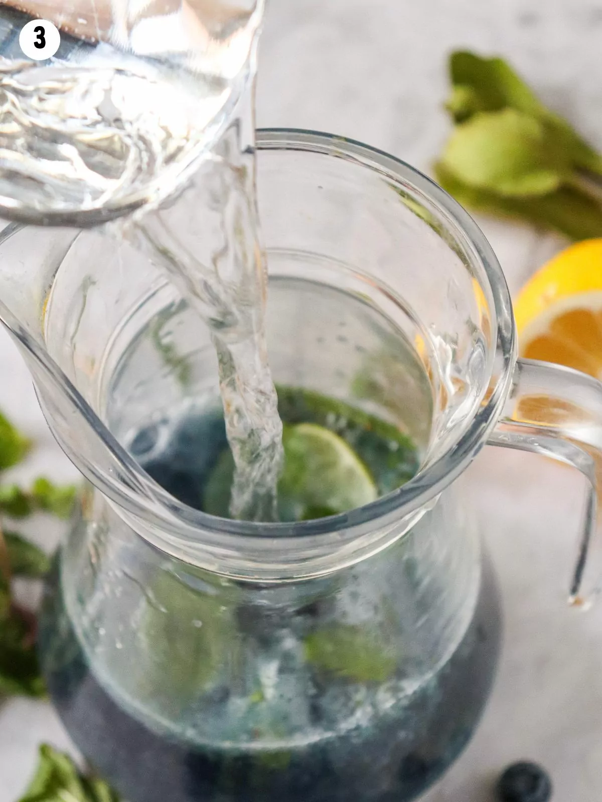 Add water to pitcher with blueberries and mint.