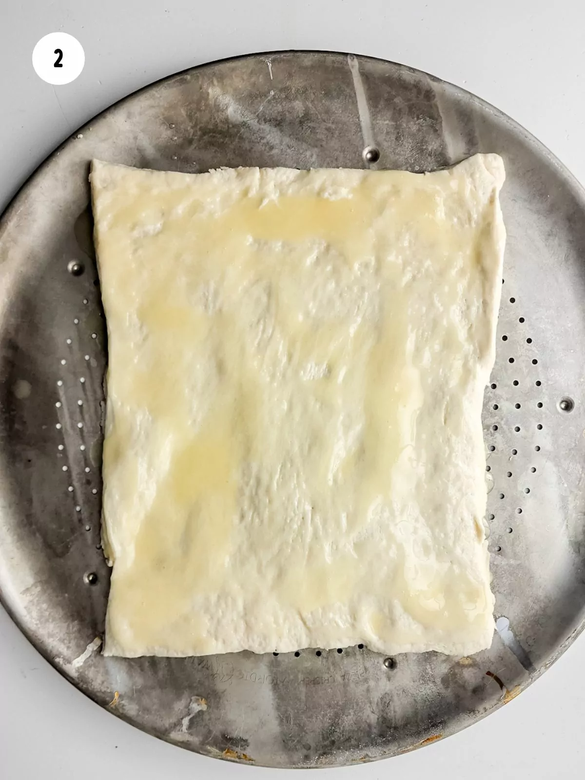 Brush butter on dough