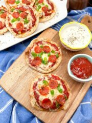 FEATURED Air Fryer English Muffin Pizza on wood cutting board and white platter