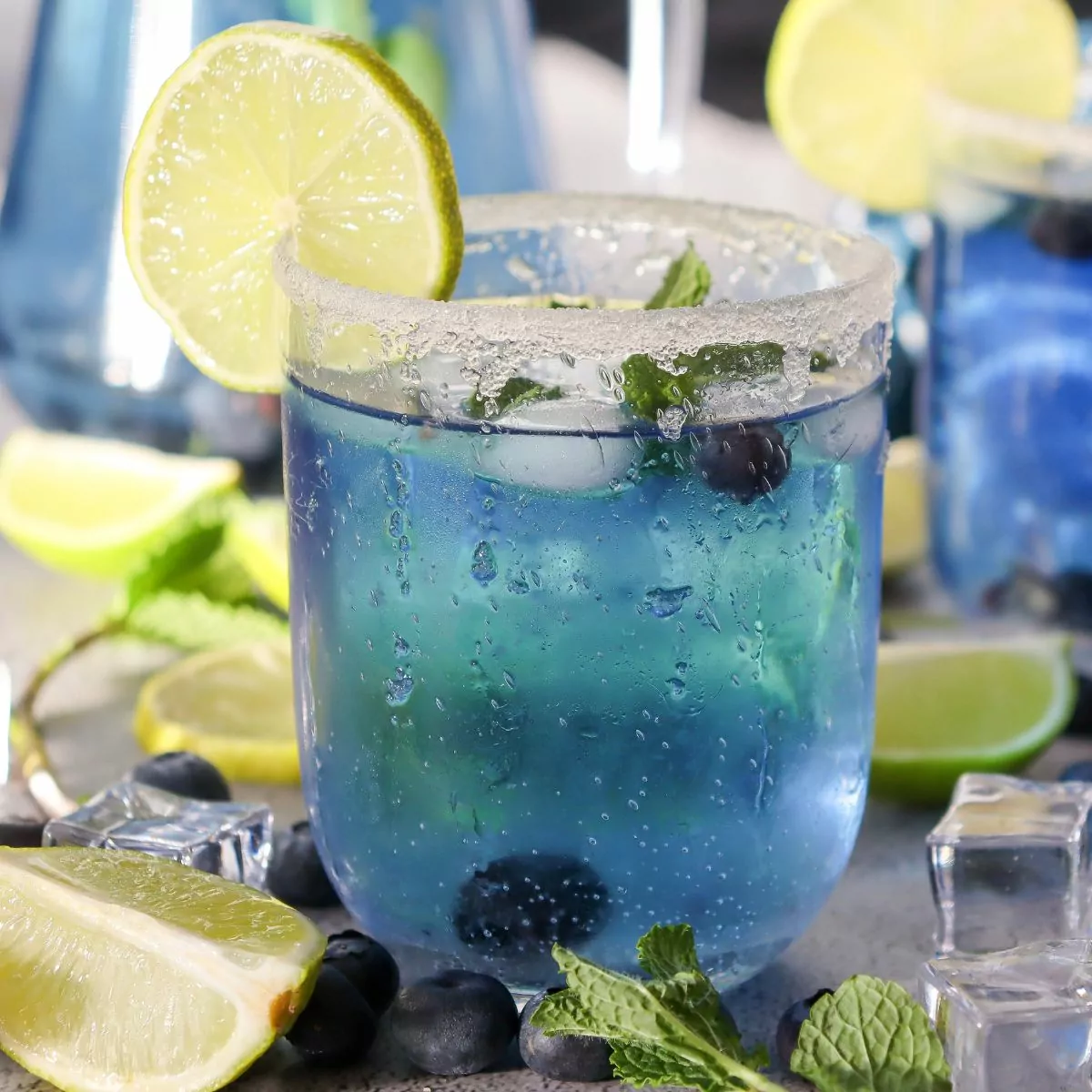 blueberry water with limes in glass.