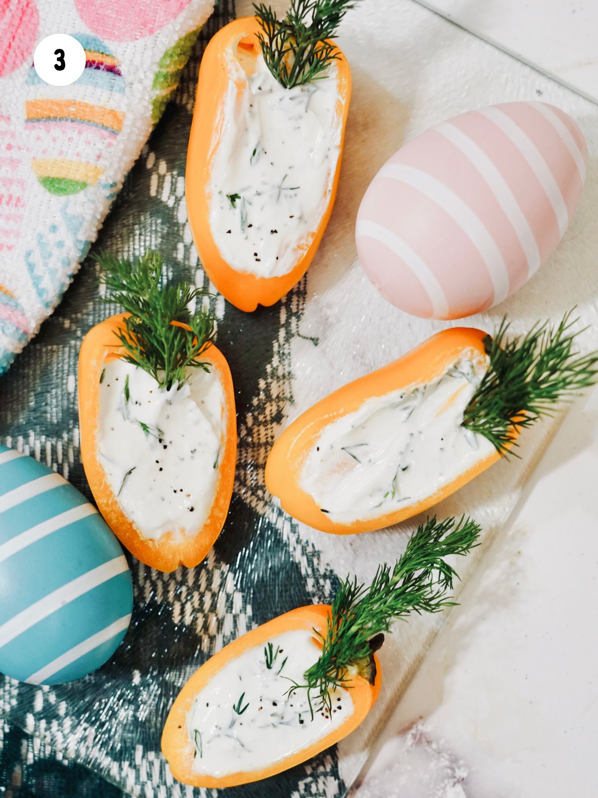 carrot peppers on tray with Easter eggs.