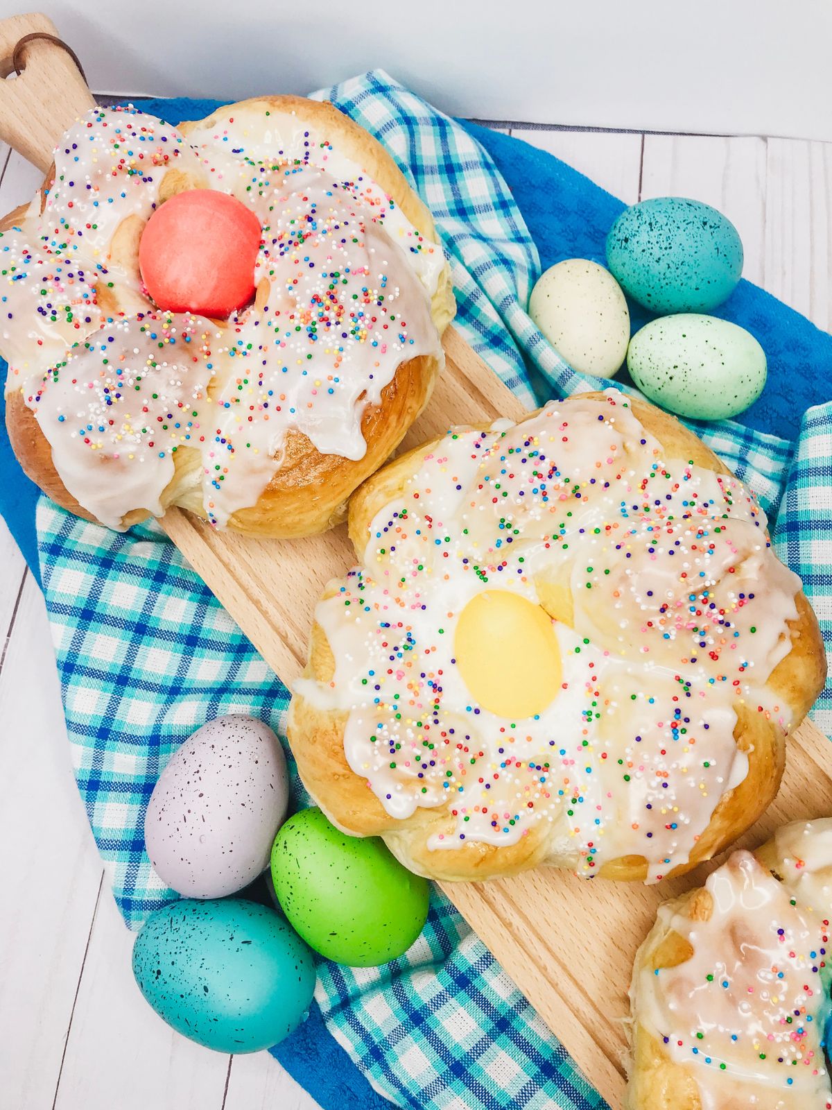 Italian Easter Rolls from Frozen Bread Dough decorated and on cutting board.