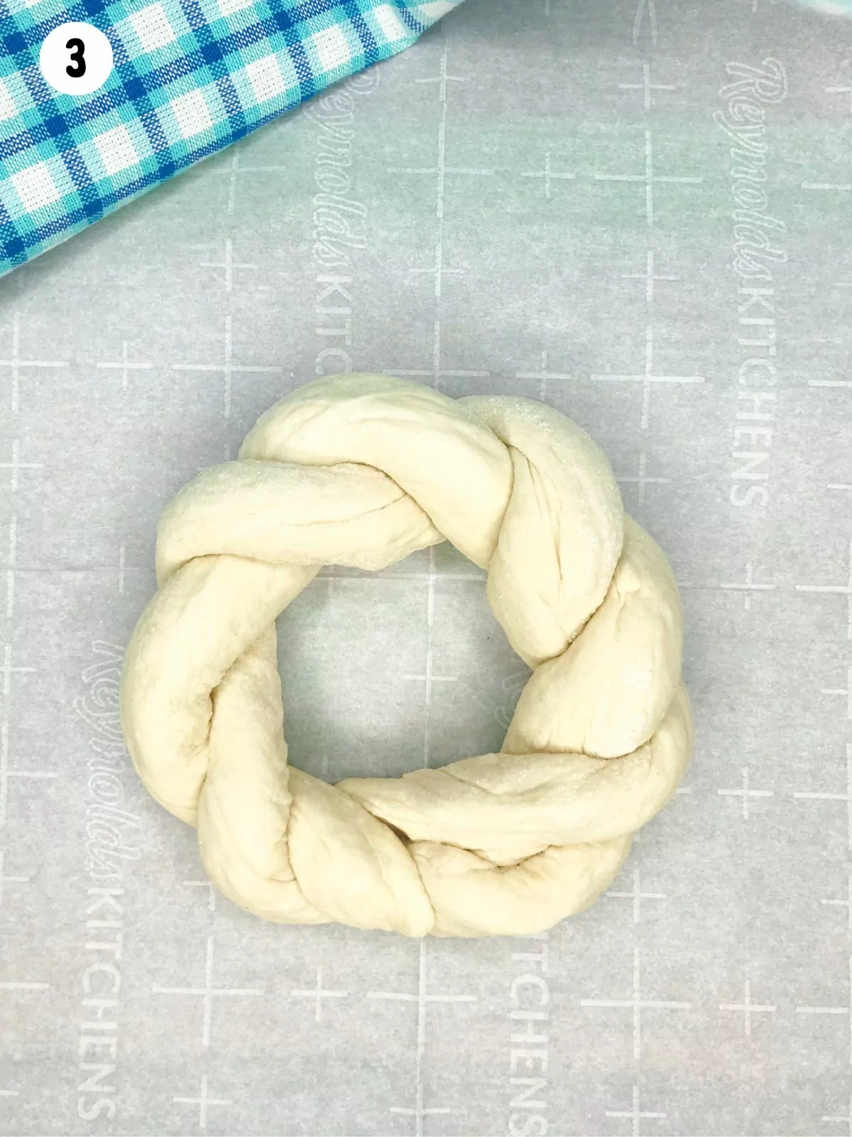 frozen bread dough defrosted and shaped into a rope ring.