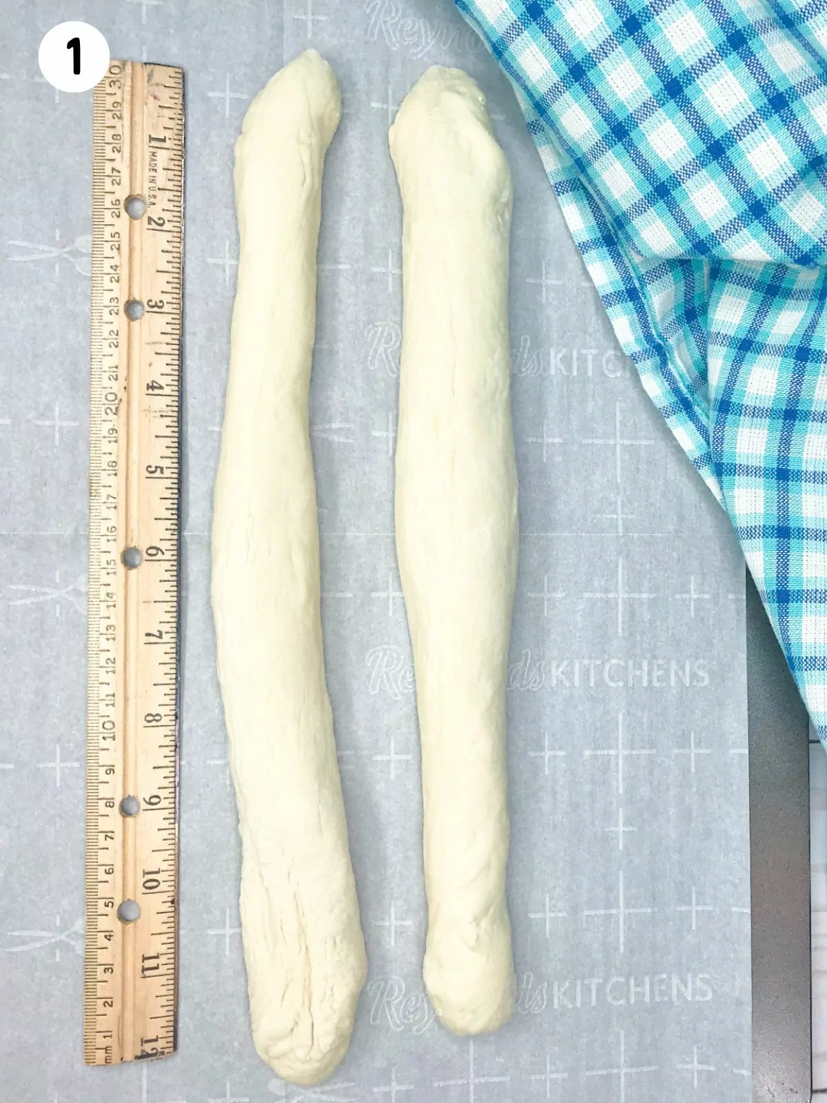 two ropes of bread dough with a ruler.