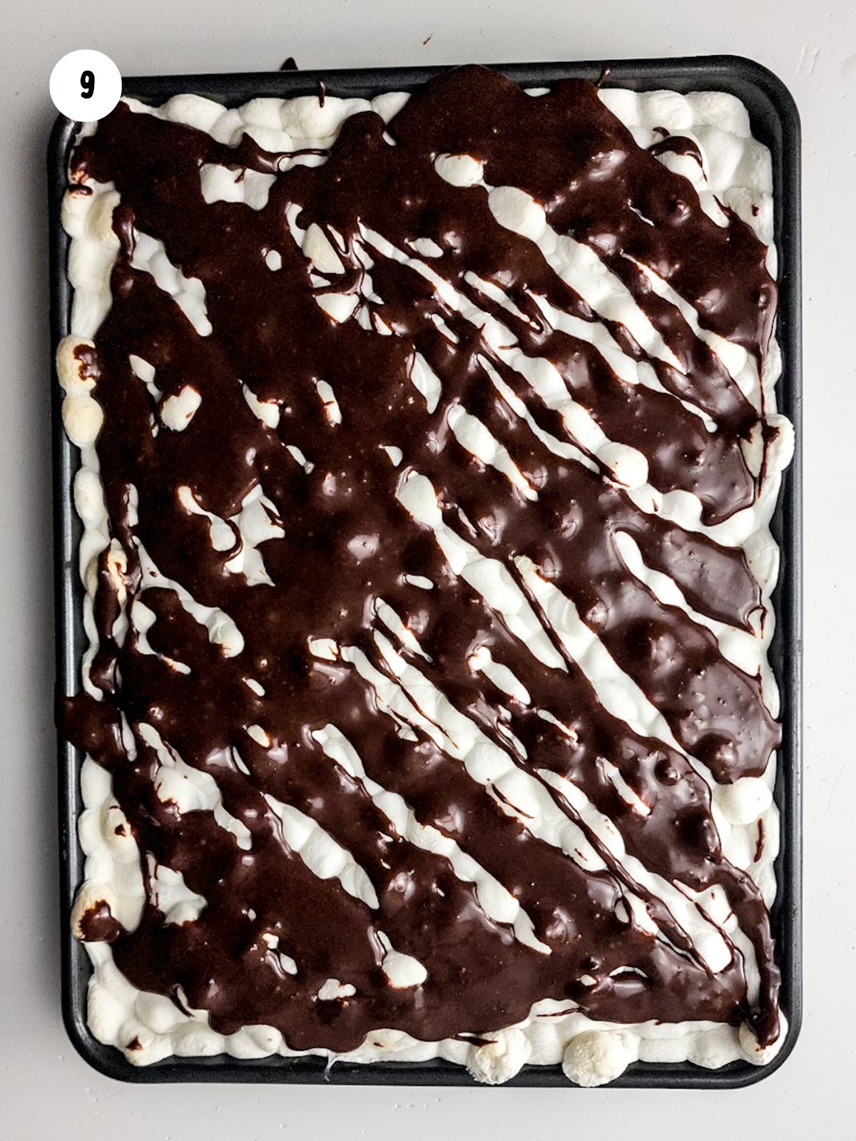 chocolate sauce on top of melted marshmallows.