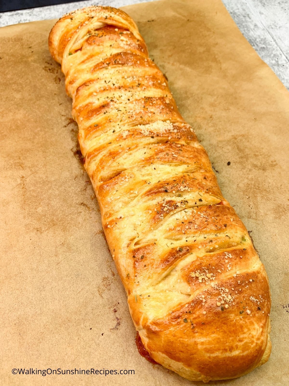 braided pizza with refrigerator pizza dough baked on parchment paper.