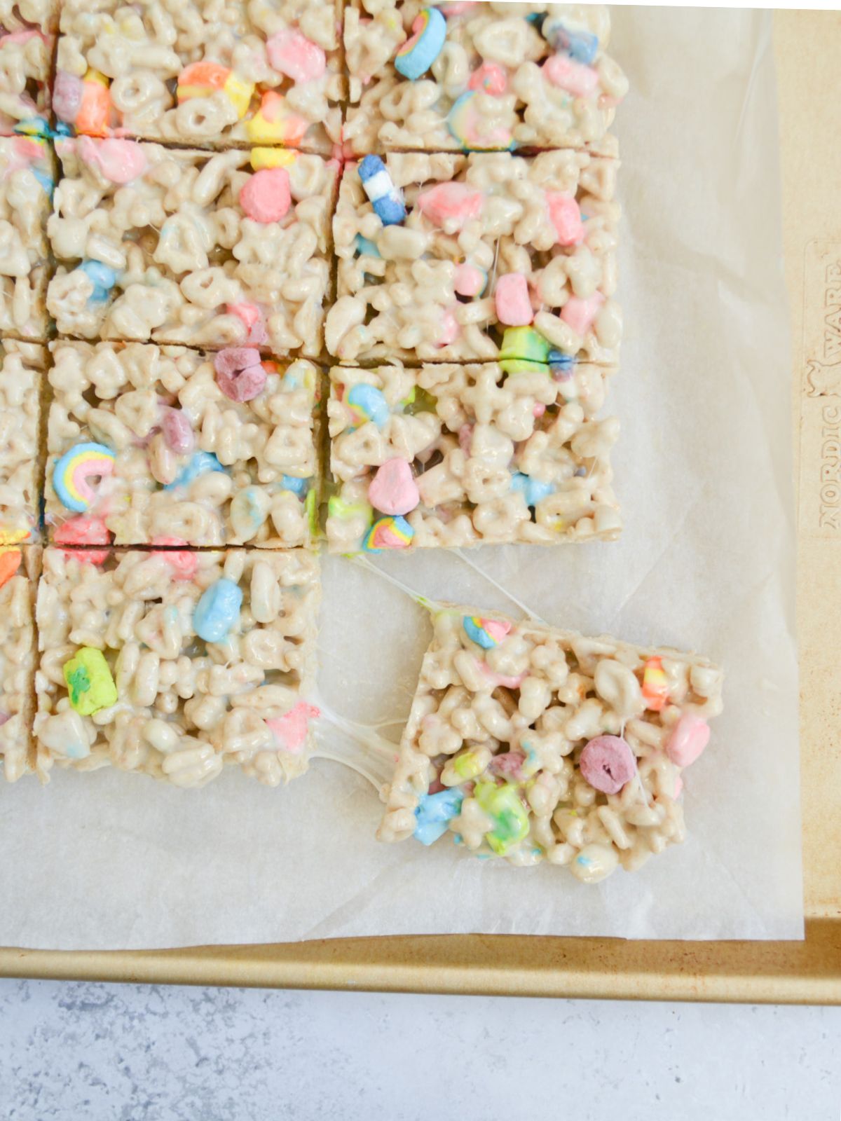 no bake cereal bars sliced and pulled apart on baking tray.