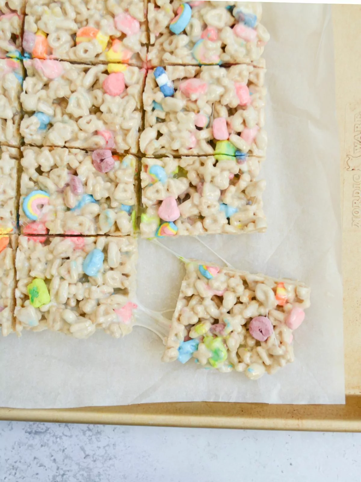 no bake cereal bars sliced and pulled apart on baking tray.