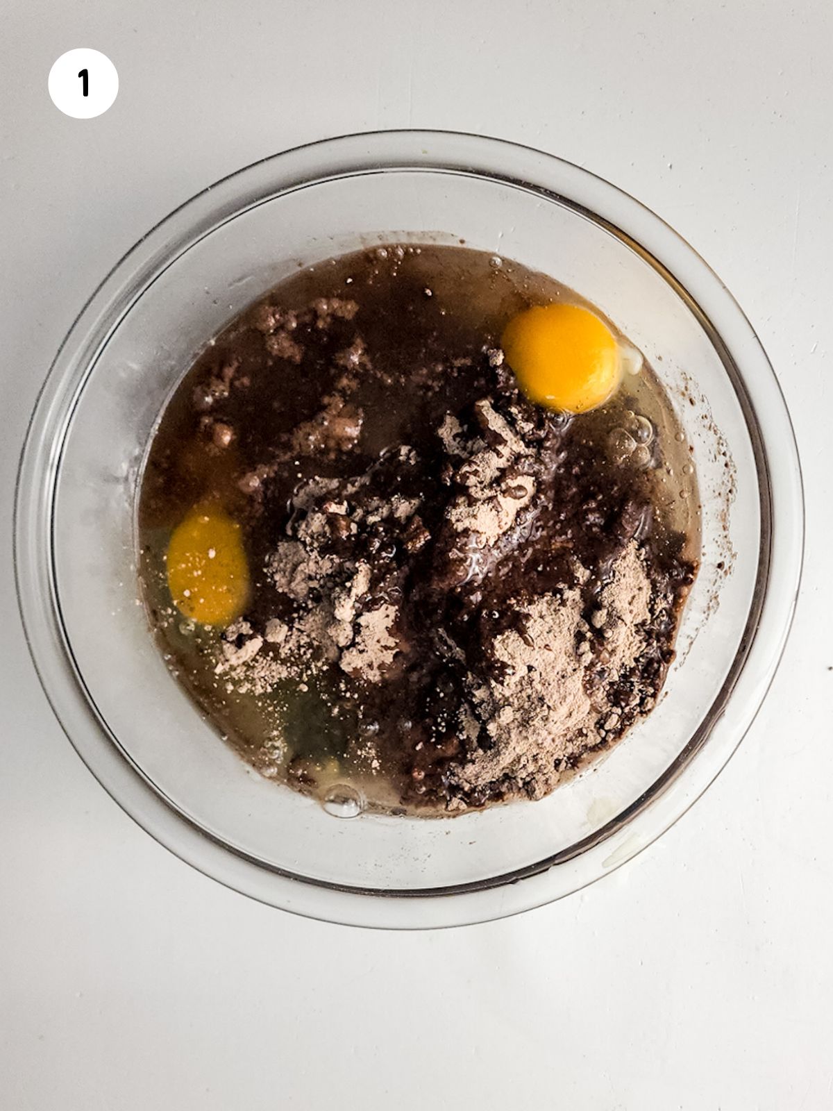 brownie batter in bowl with eggs.