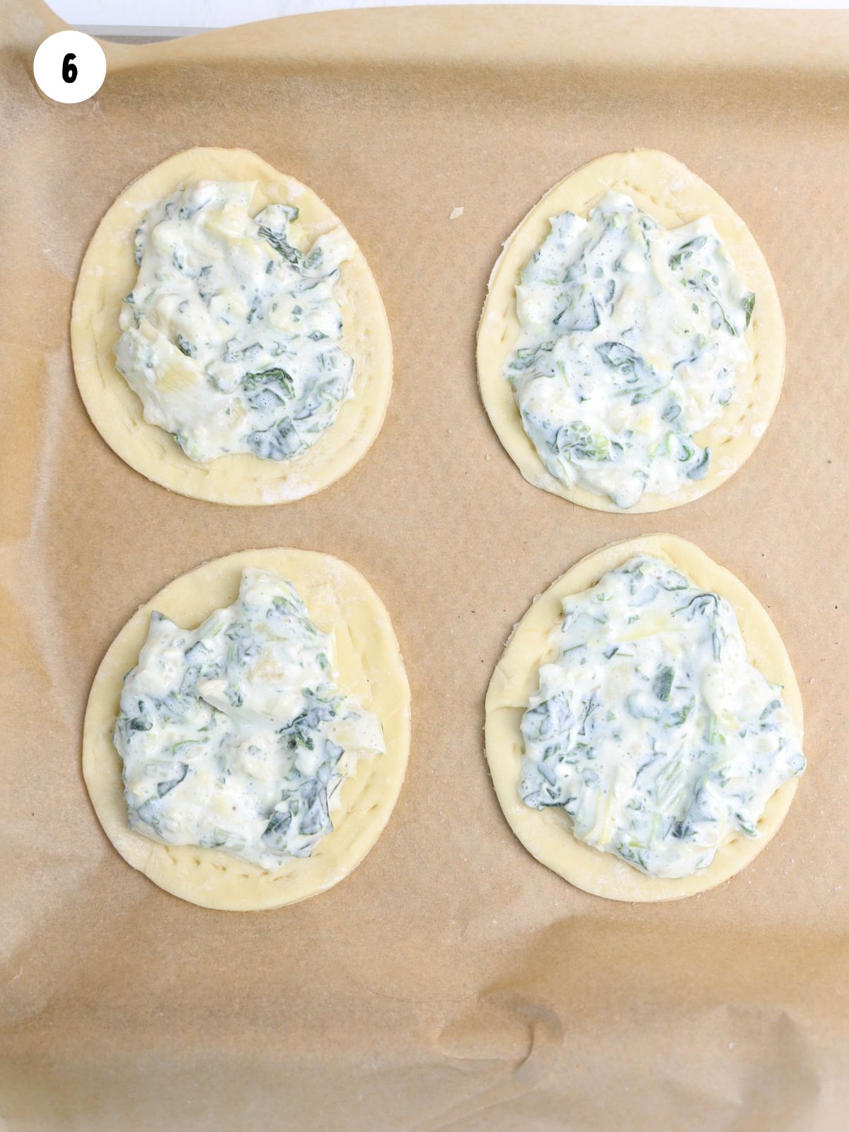 egg shaped puff pastry with spinach artichoke dip.