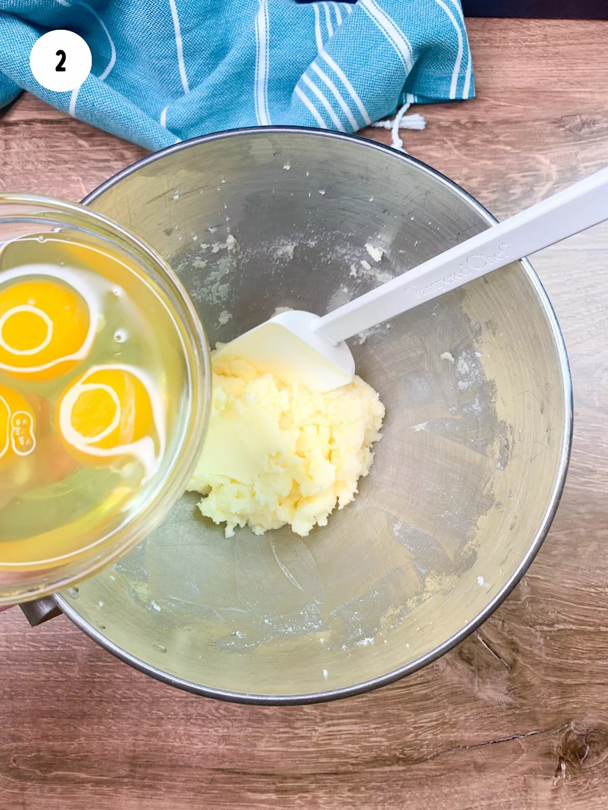 adding eggs to creamed butter and sugar in mixing bowl.