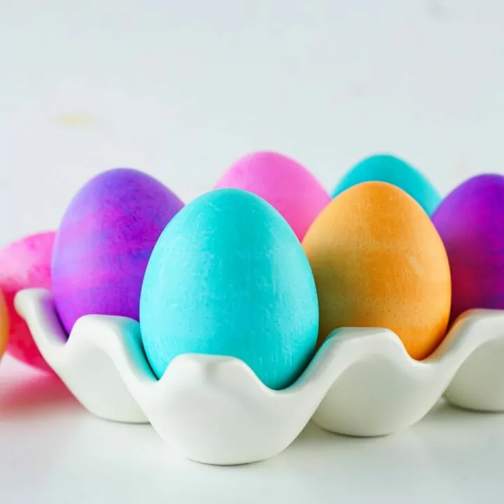 dyed eggs in ceramic egg holder.