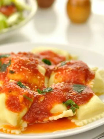 square cheese filled ravioli on plate.