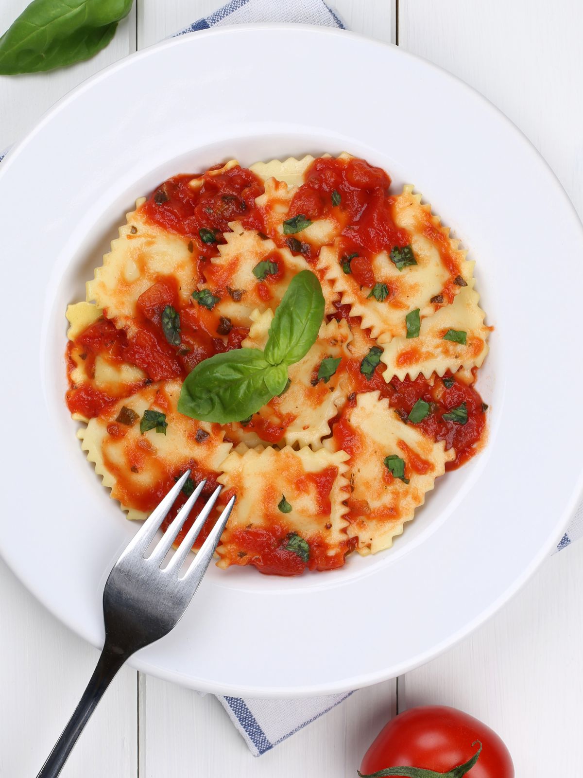 overhead view of cheese ravioli with tomato sauce.