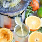 Using a juice machine to squeeze citrus.