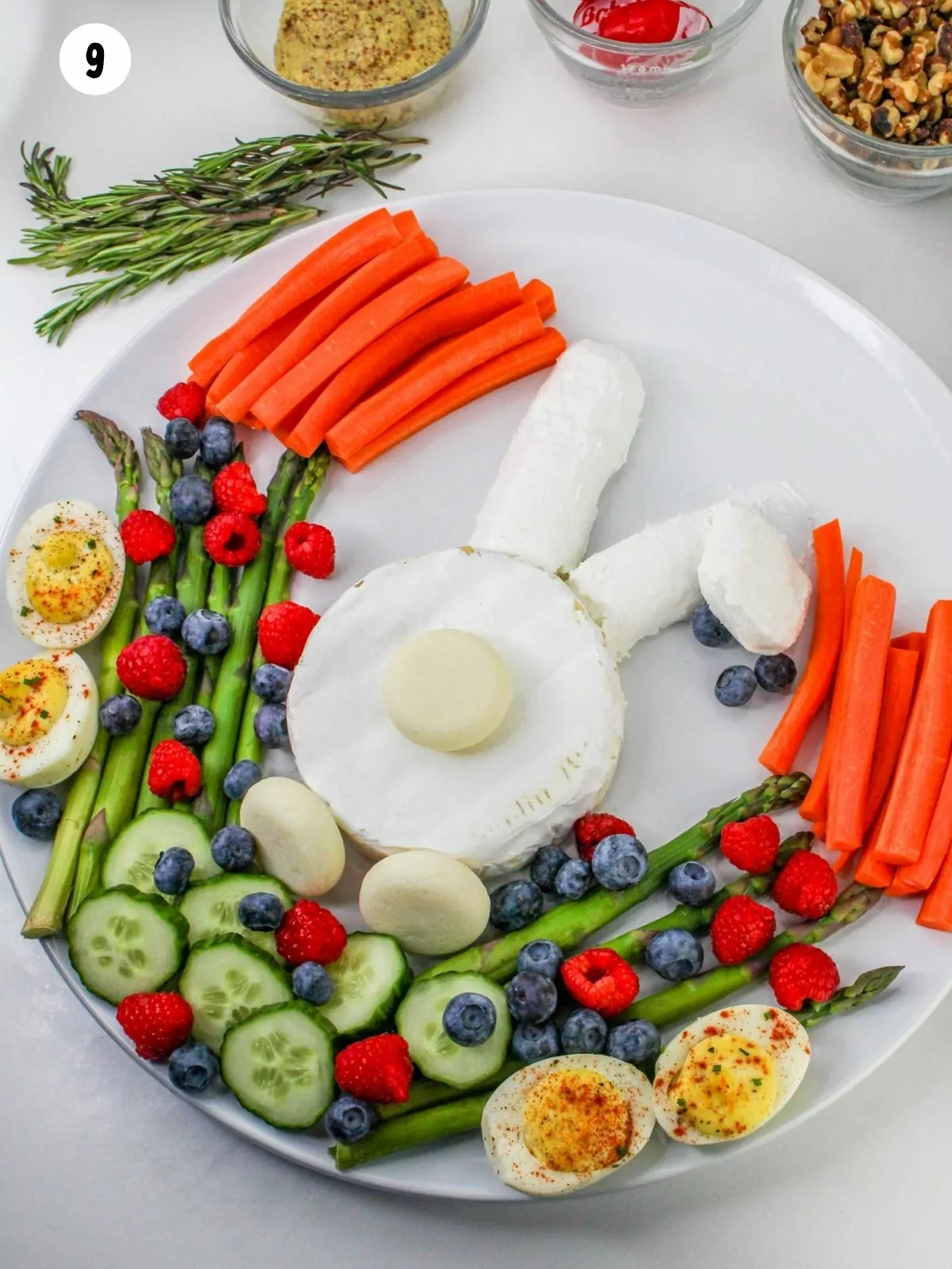 assorted veggies and fruit with bunny cheese on platter.