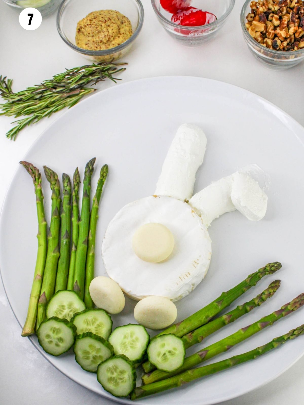 Adding veggies to bunny cheese platter.