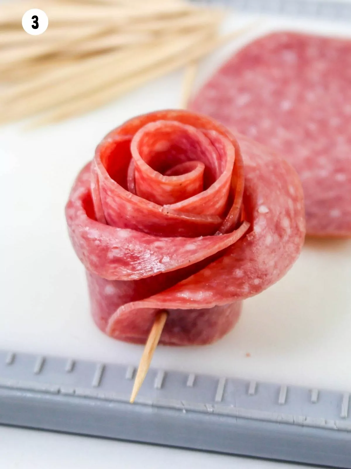 salami rose with toothpick.