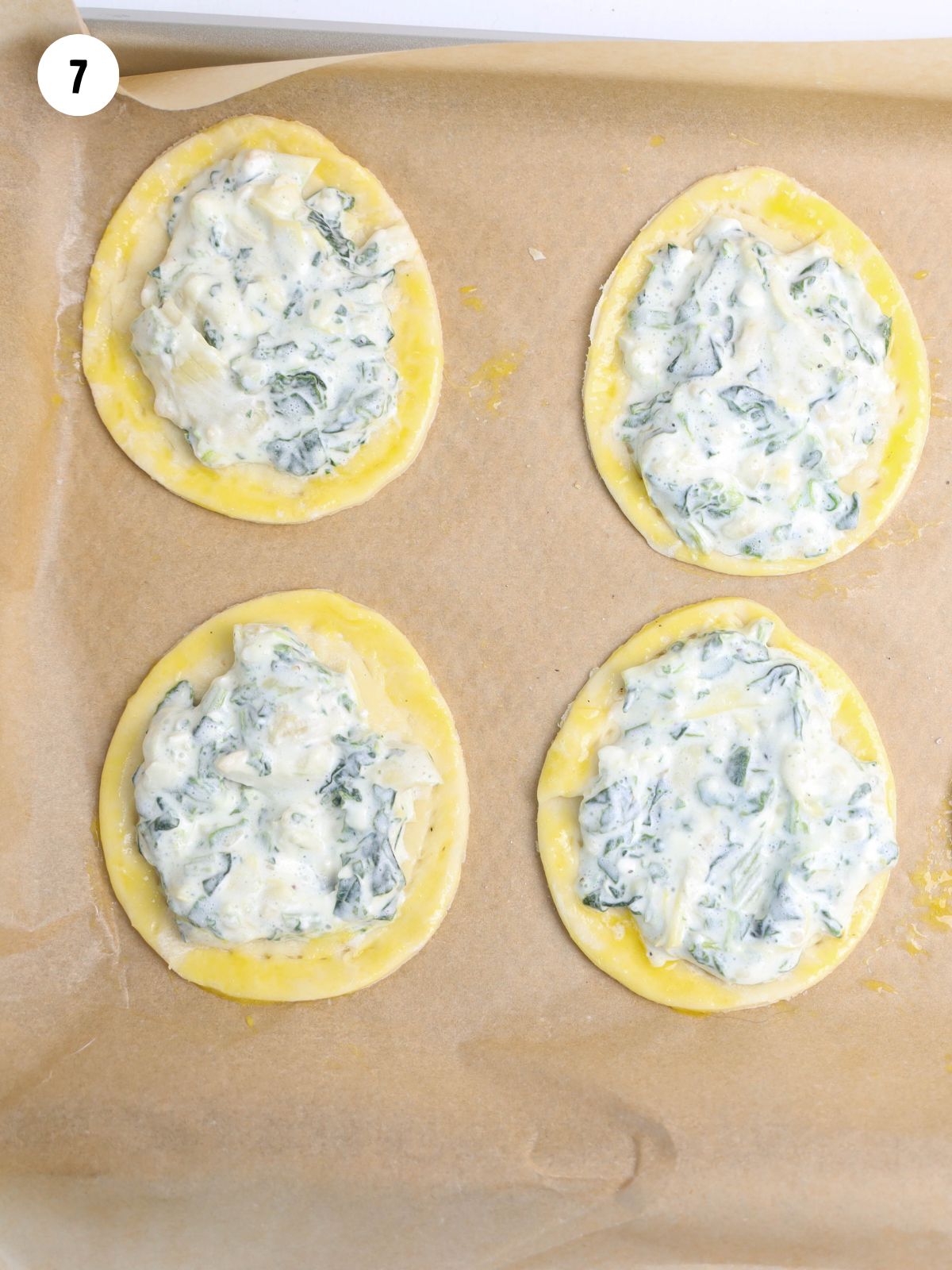 egg wash brushed on egg shaped puff pastry.