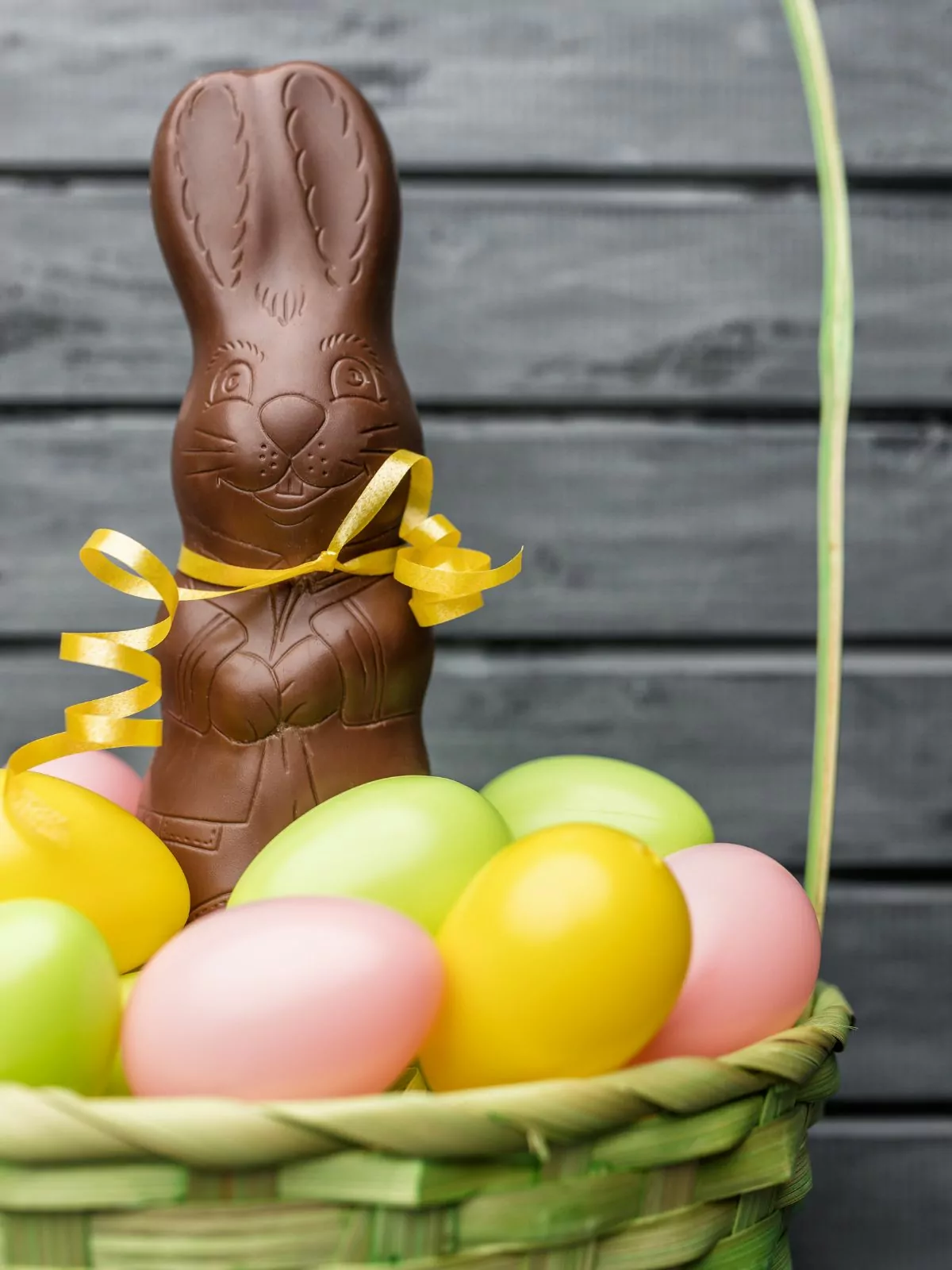 chocolate bunny in basket with plastic eggs.