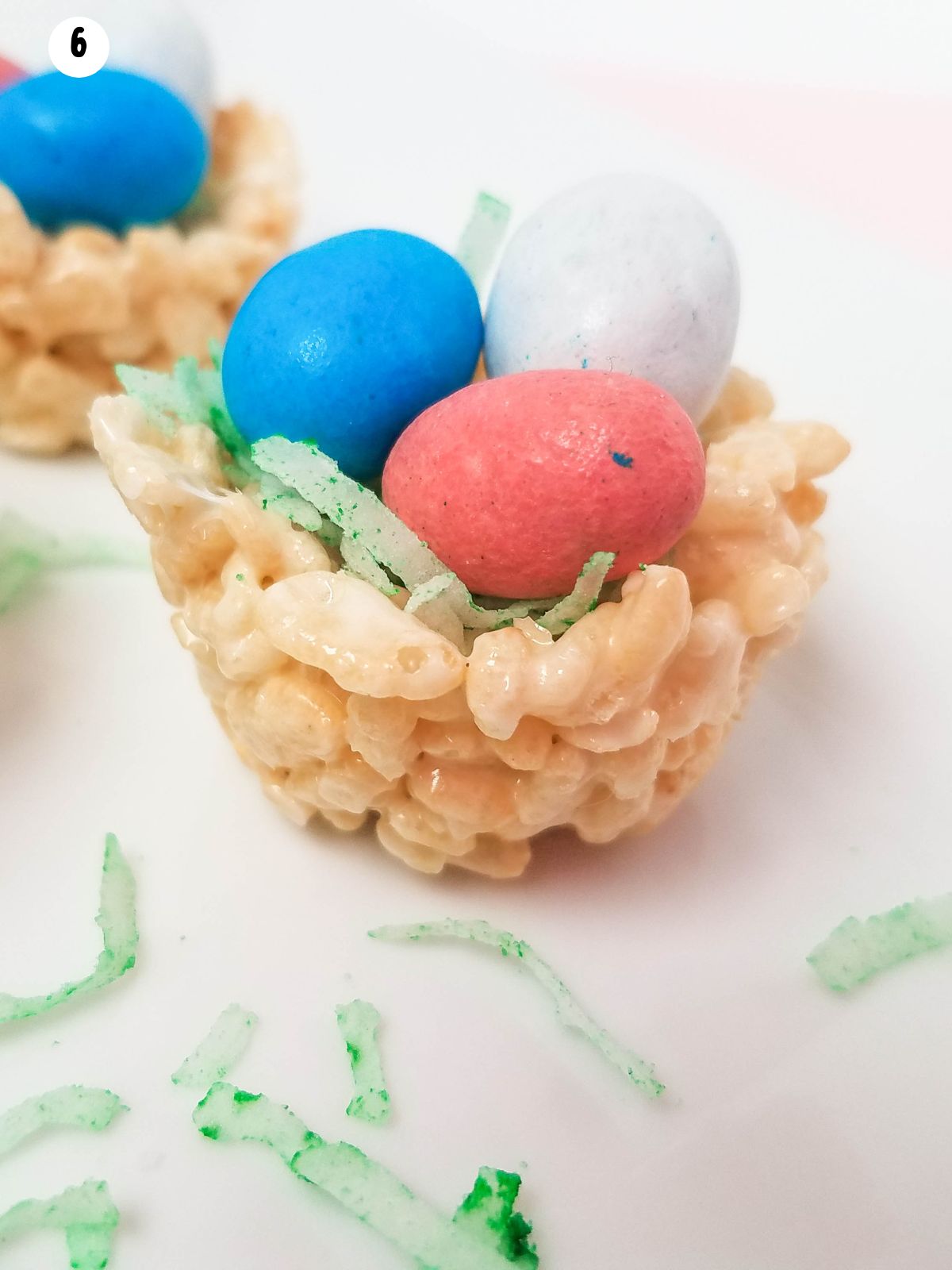 closeup of egg candy in marshmallow cereal nests.