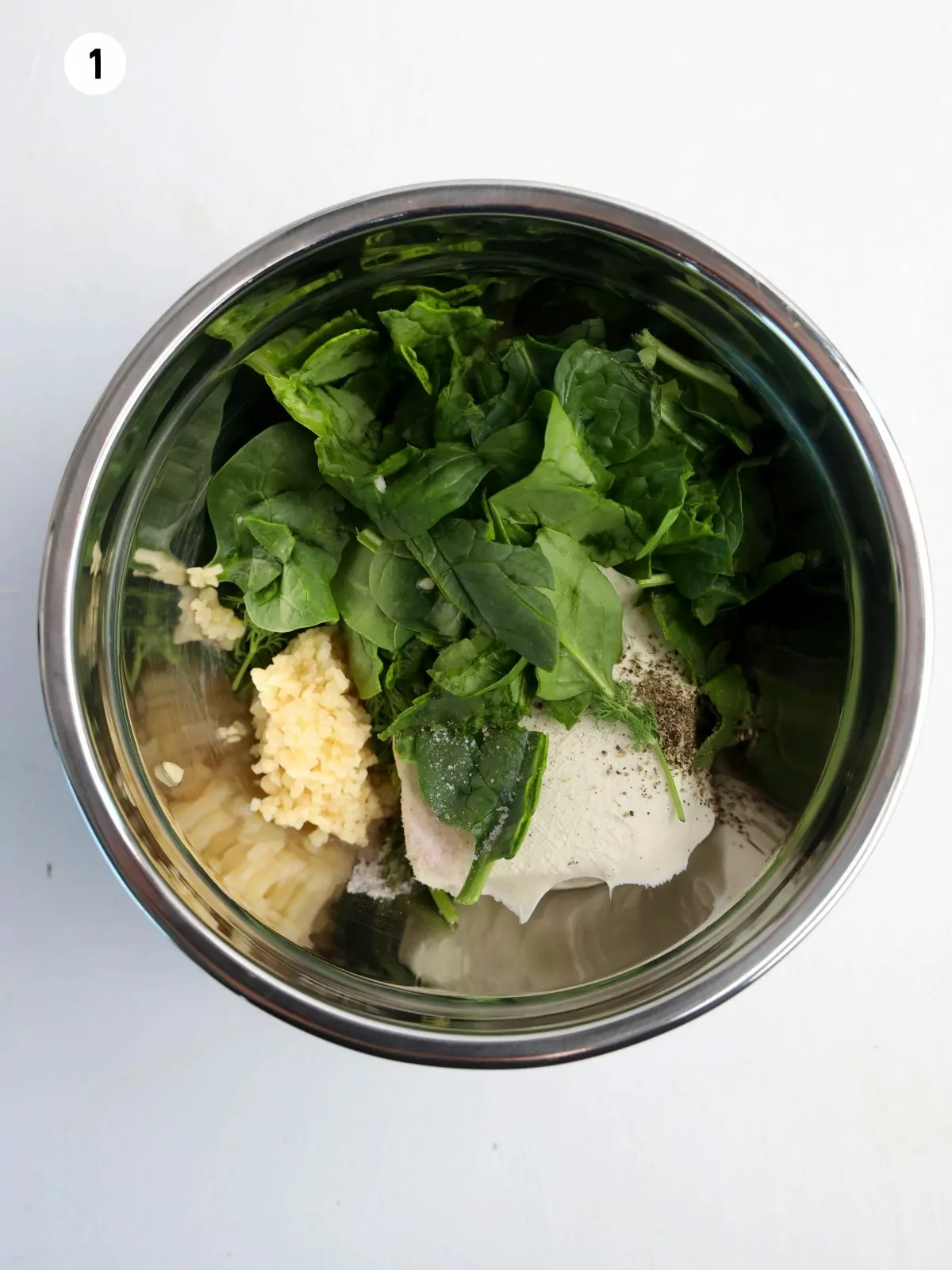 spinach dip ingredients in metal bowl.