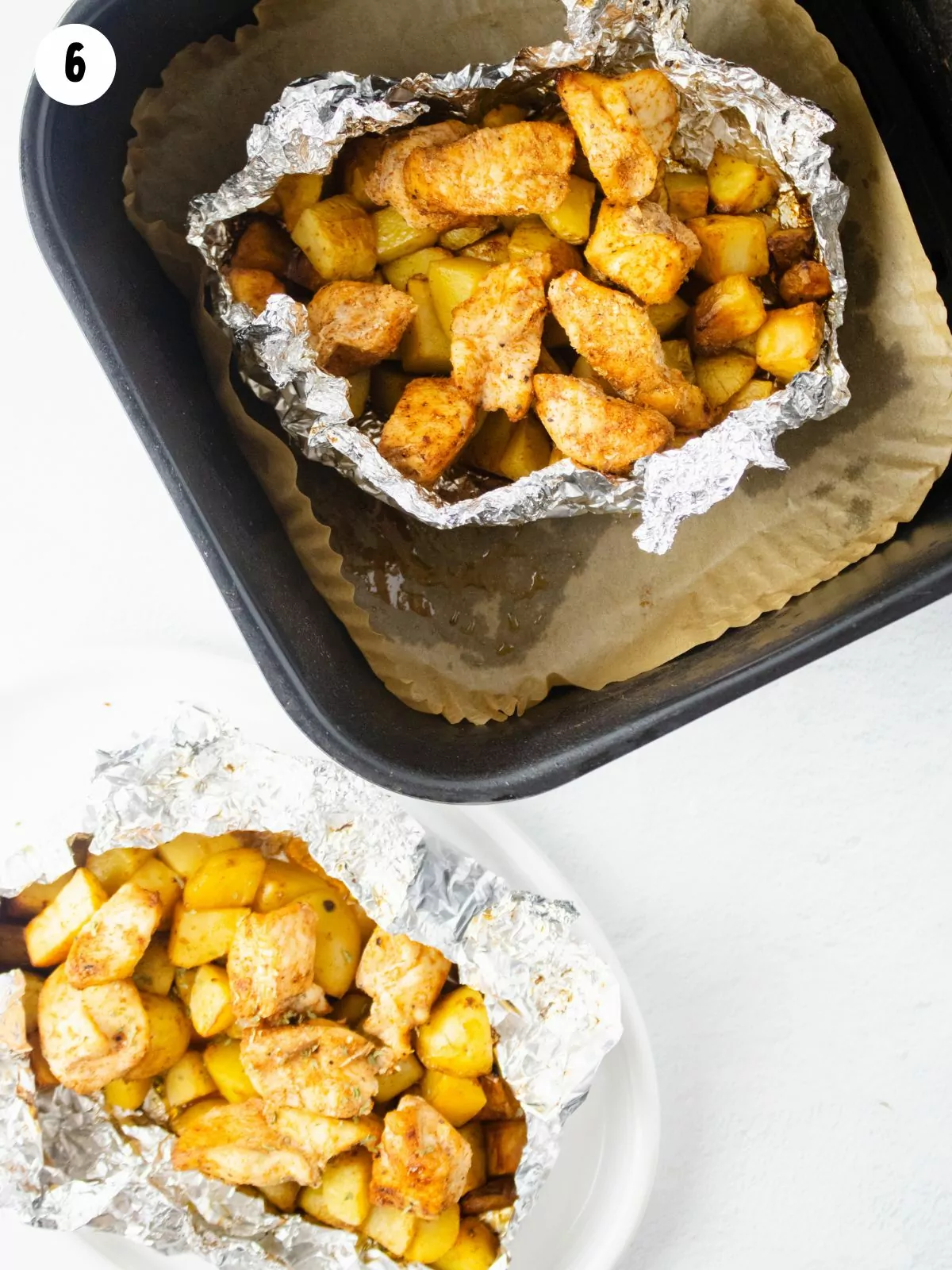 cooked chicken, potatoes in aluminum foil bundles.