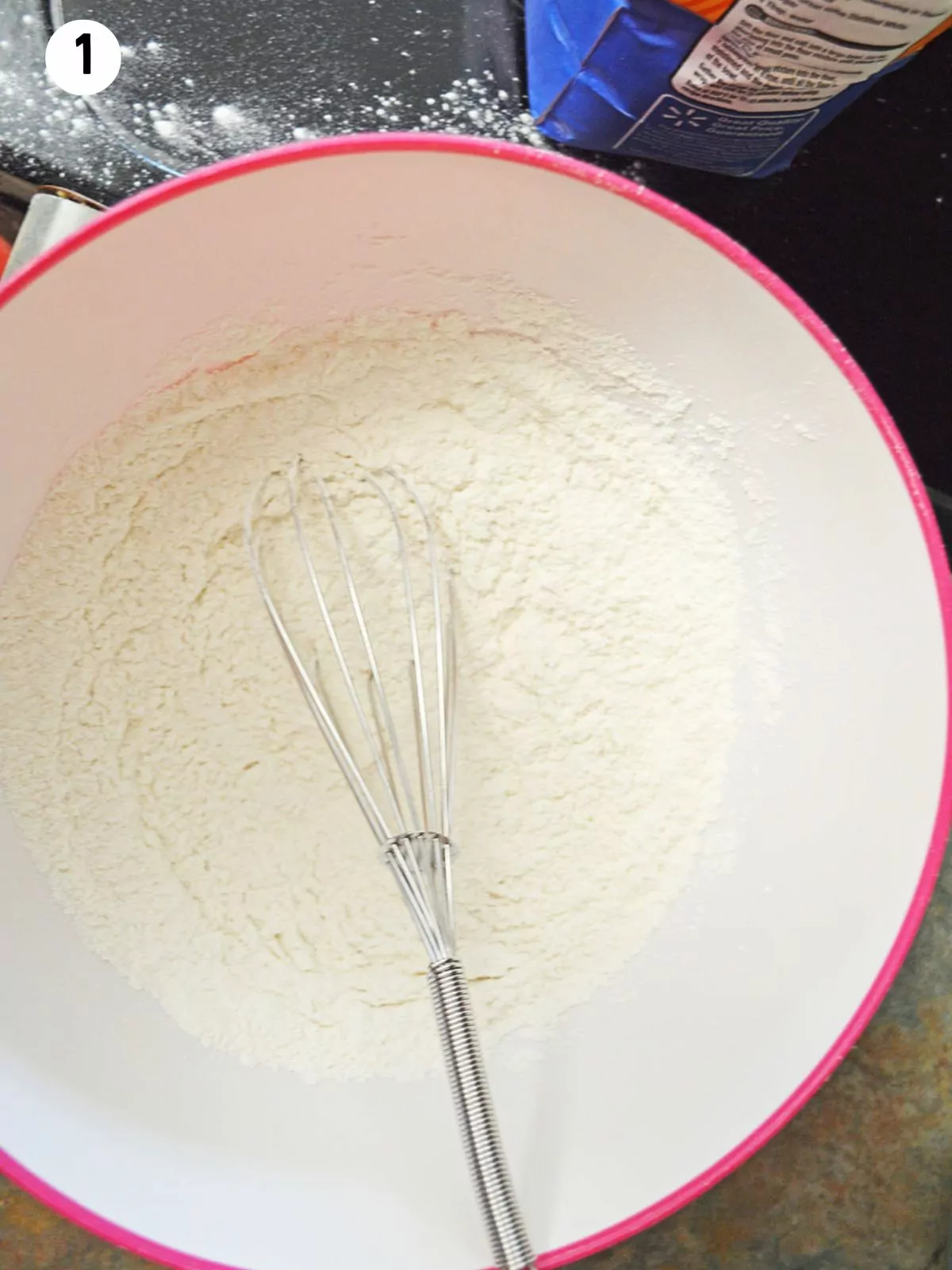 flour with wire whisk in bowl.