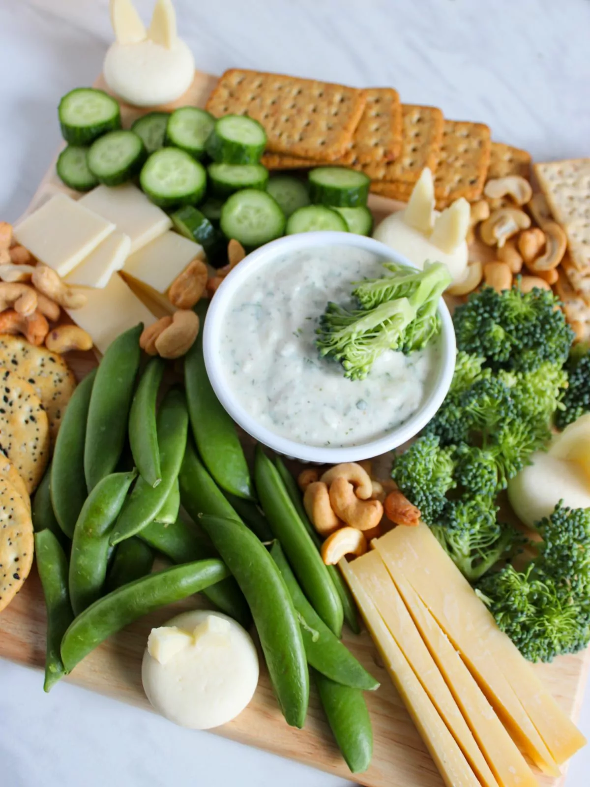 broccoli, sugar snap peas, cheese, nuts and more on board.