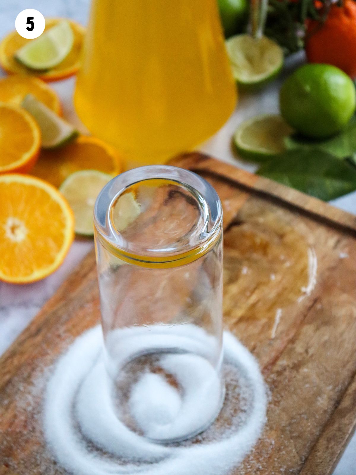 rub rim of glass in salt on cutting board.