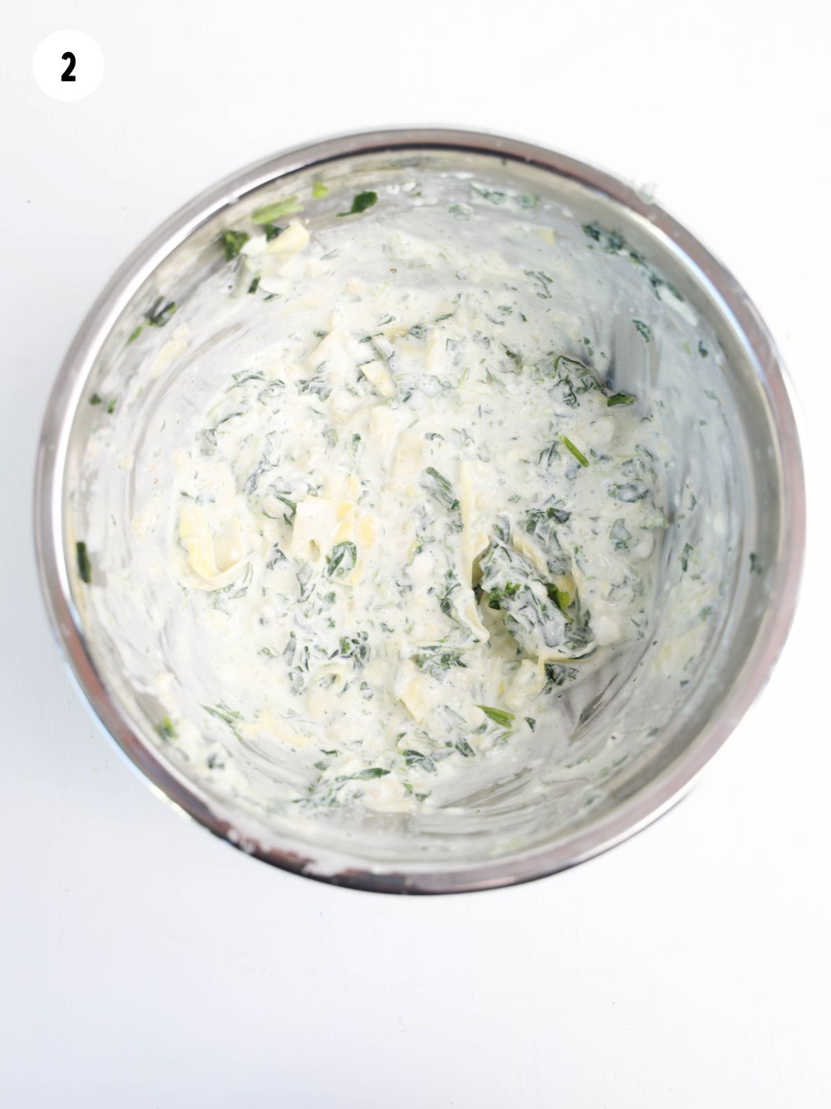 spinach artichoke dip in metal bowl.