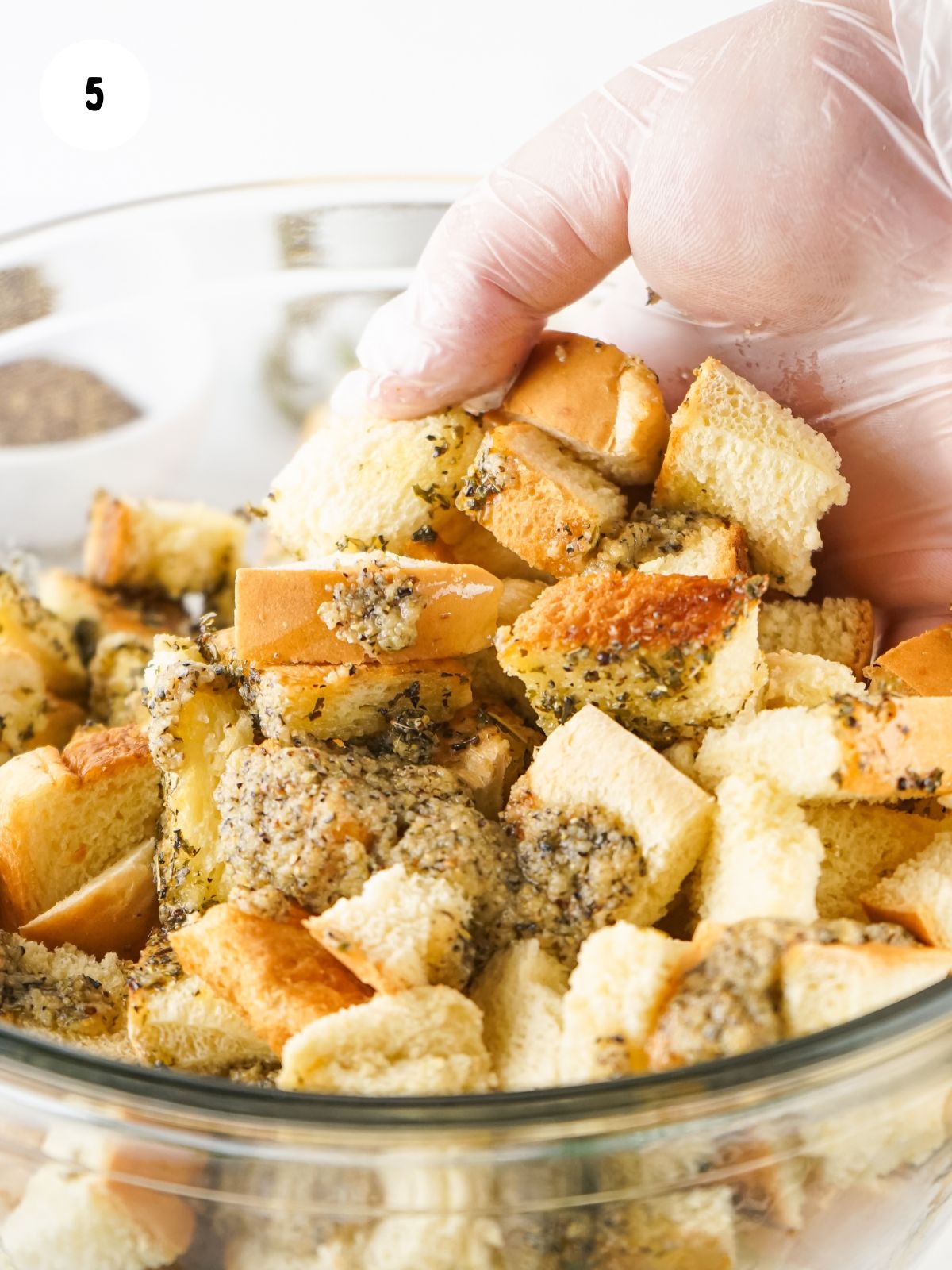 tossing melted butter with herbs and bread cubes.