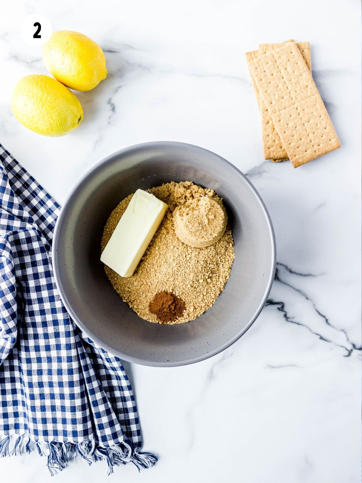 Ingredients for graham cracker crust in bowl.