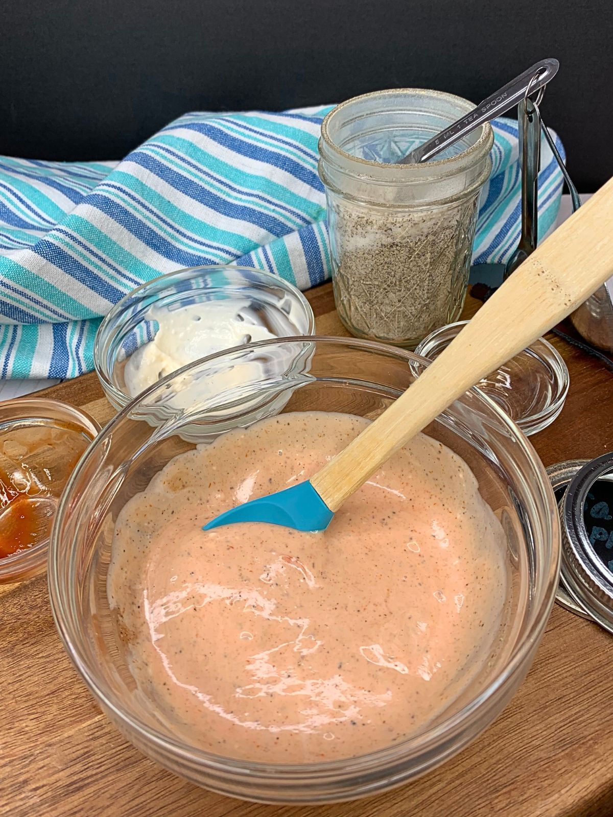 ingredients for pizza dipping sauce combined in bowl with rubber spatula.
