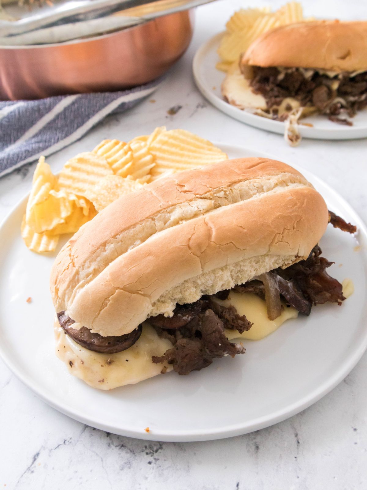 Philly Cheesesteak on white plate.