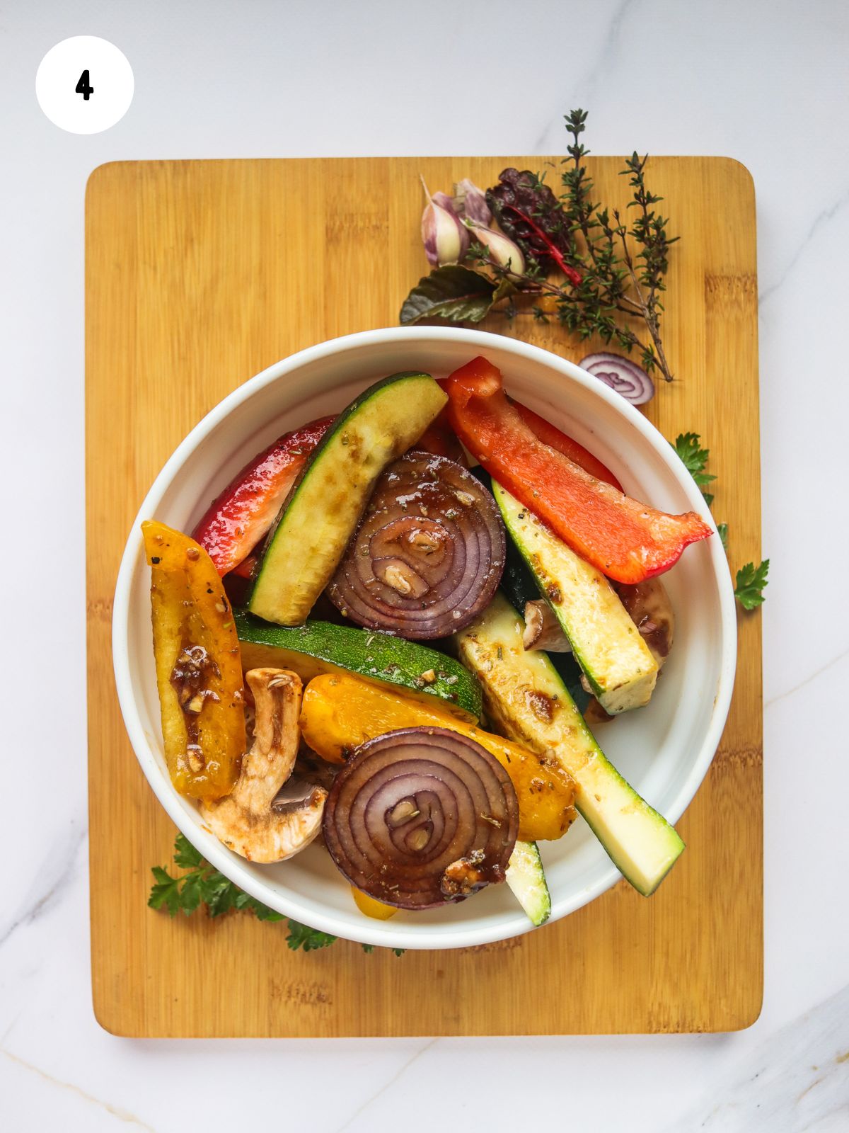 vegetables in bowl with oil and seasonings.