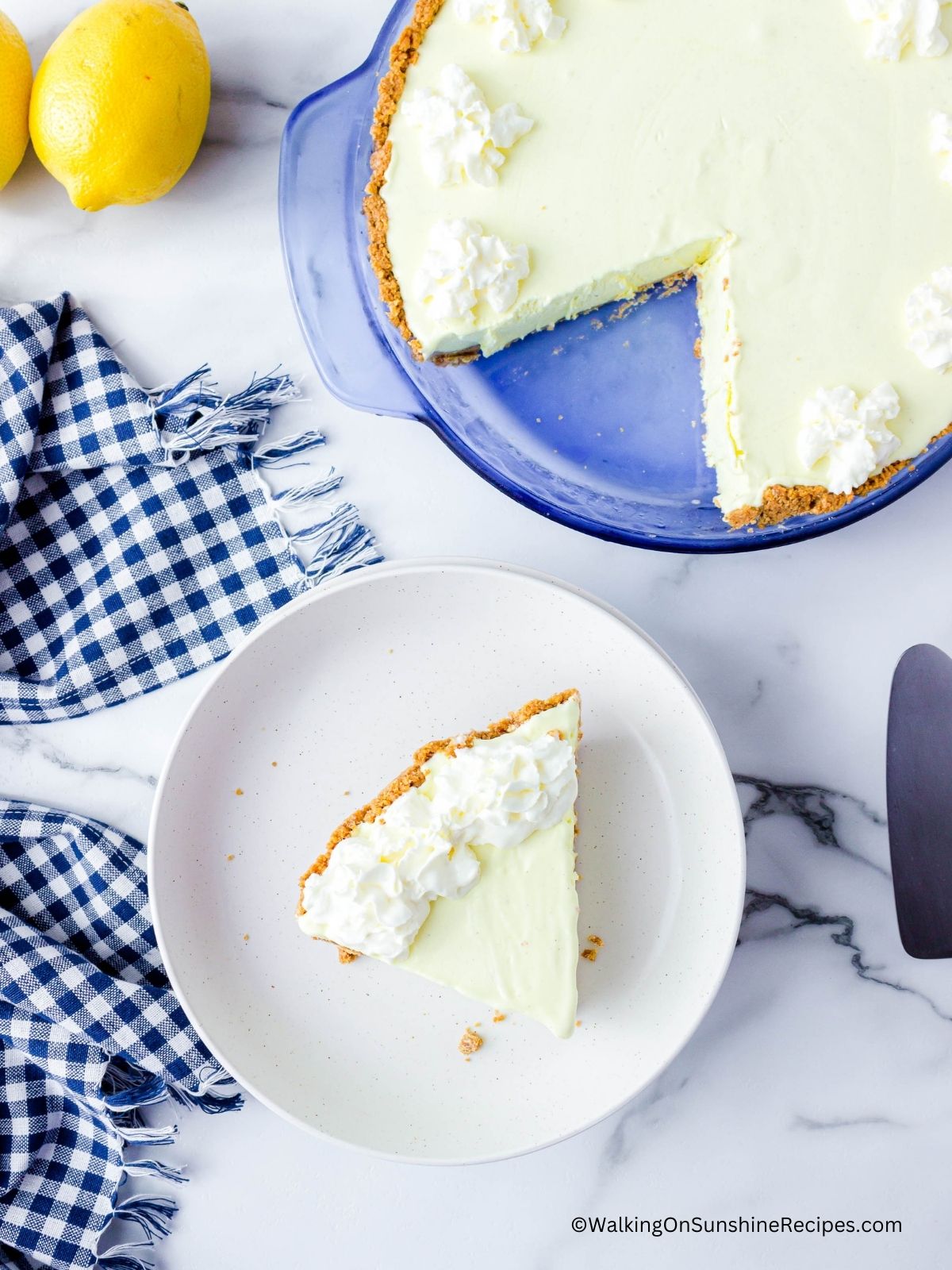 pie sliced and served on white plate with whipped cream on top.