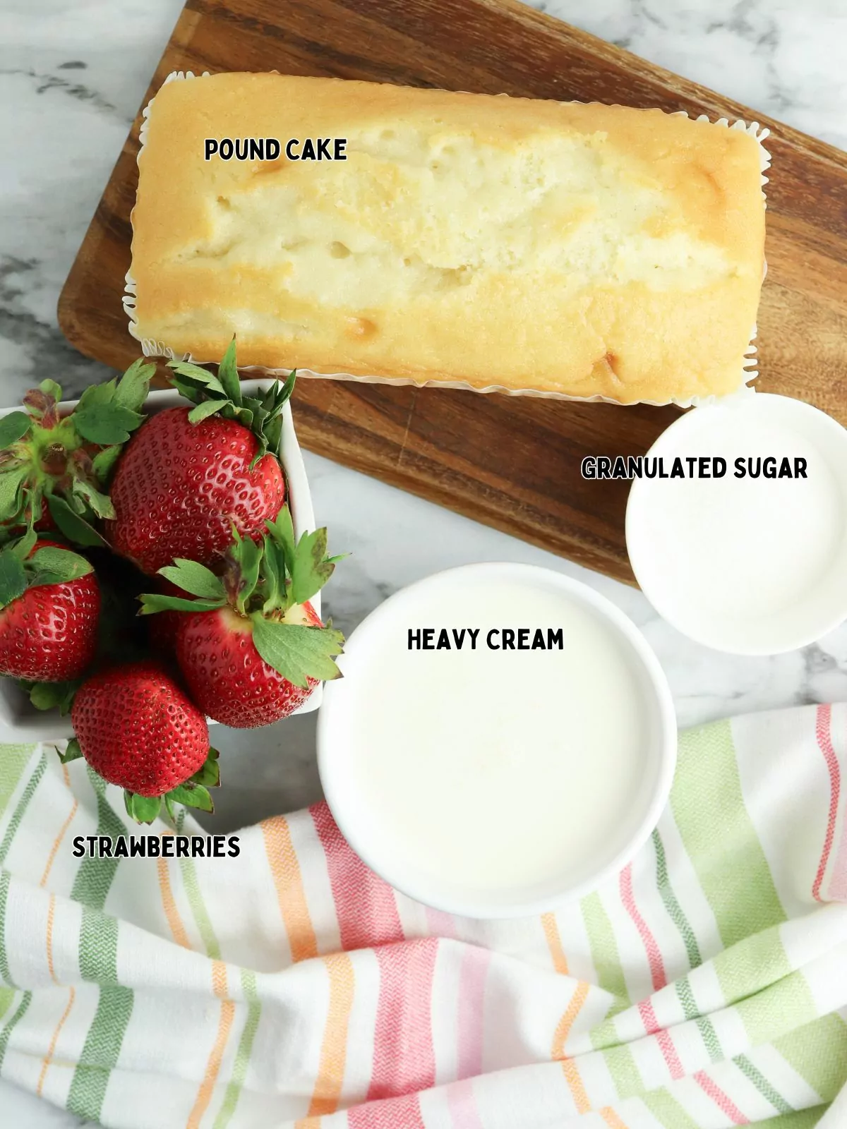 ingredients of pound cake, heavy cream, sugar and strawberries.
