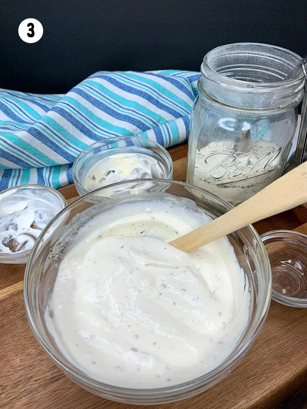 ranch dip in glass bowl with spatula.
