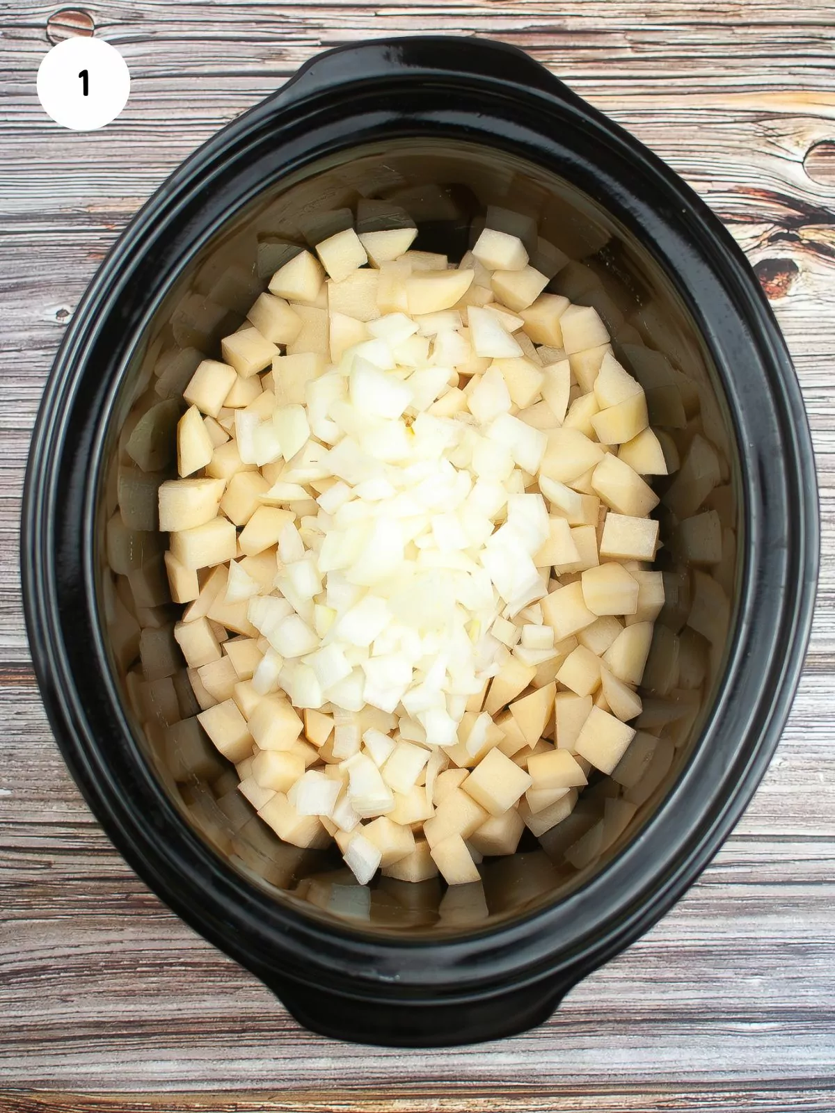 Add chopped potatoes and onion to slow cooker