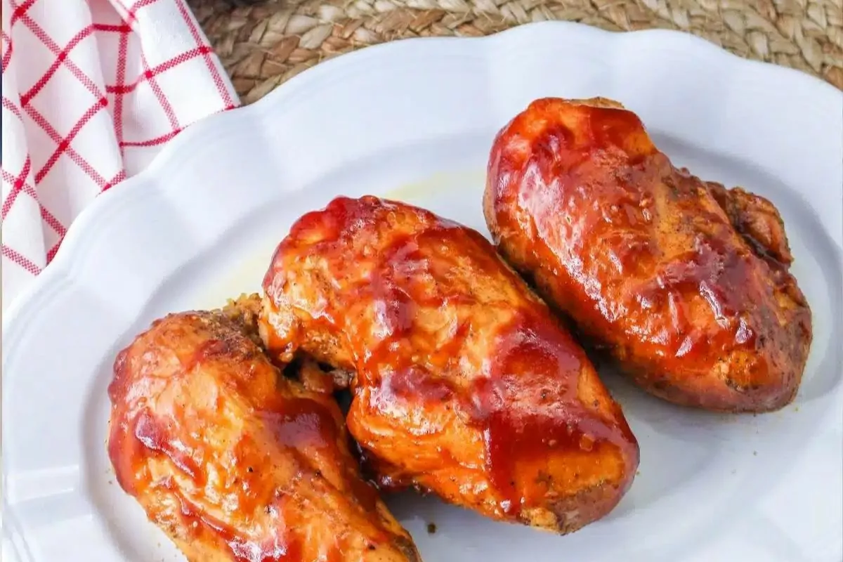 3 chicken breasts cooked with barbecue sauce.