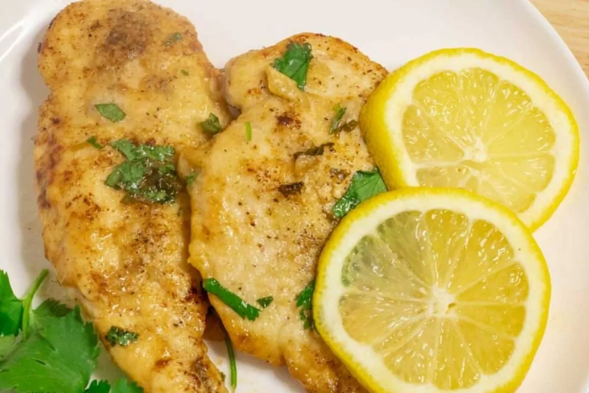 chicken with lemon slices and parsley.