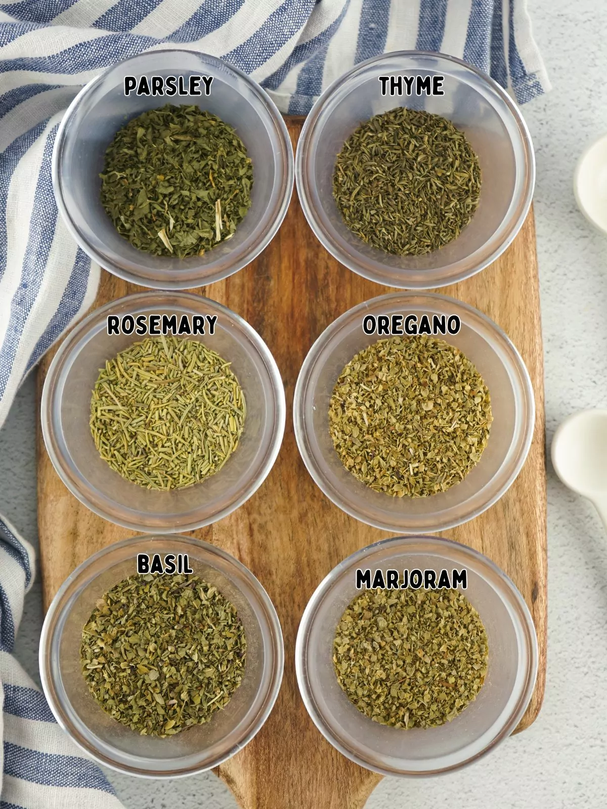 spice ingredients in small bowls on cutting board.