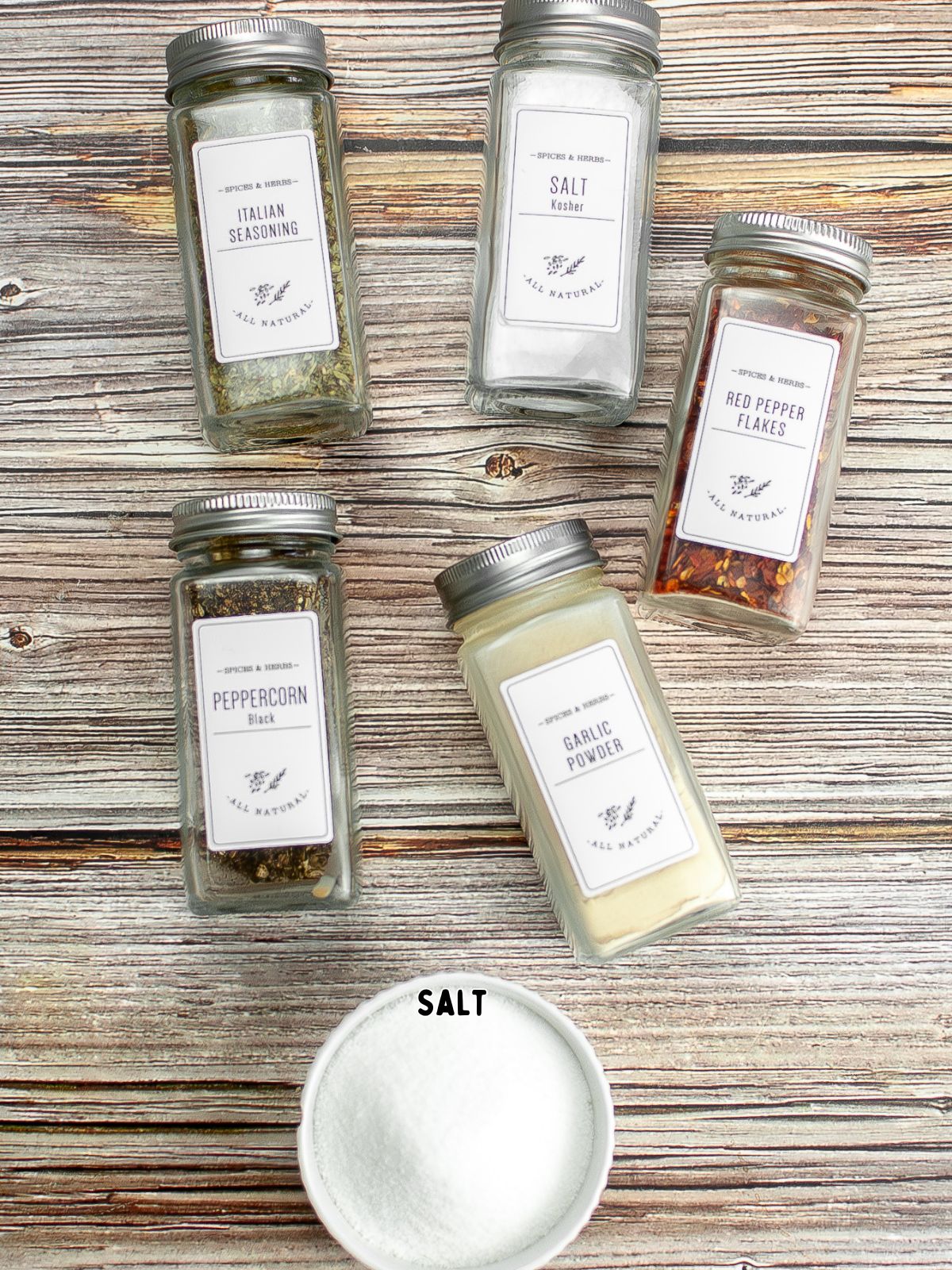 spices in jars with a bowl of salt.