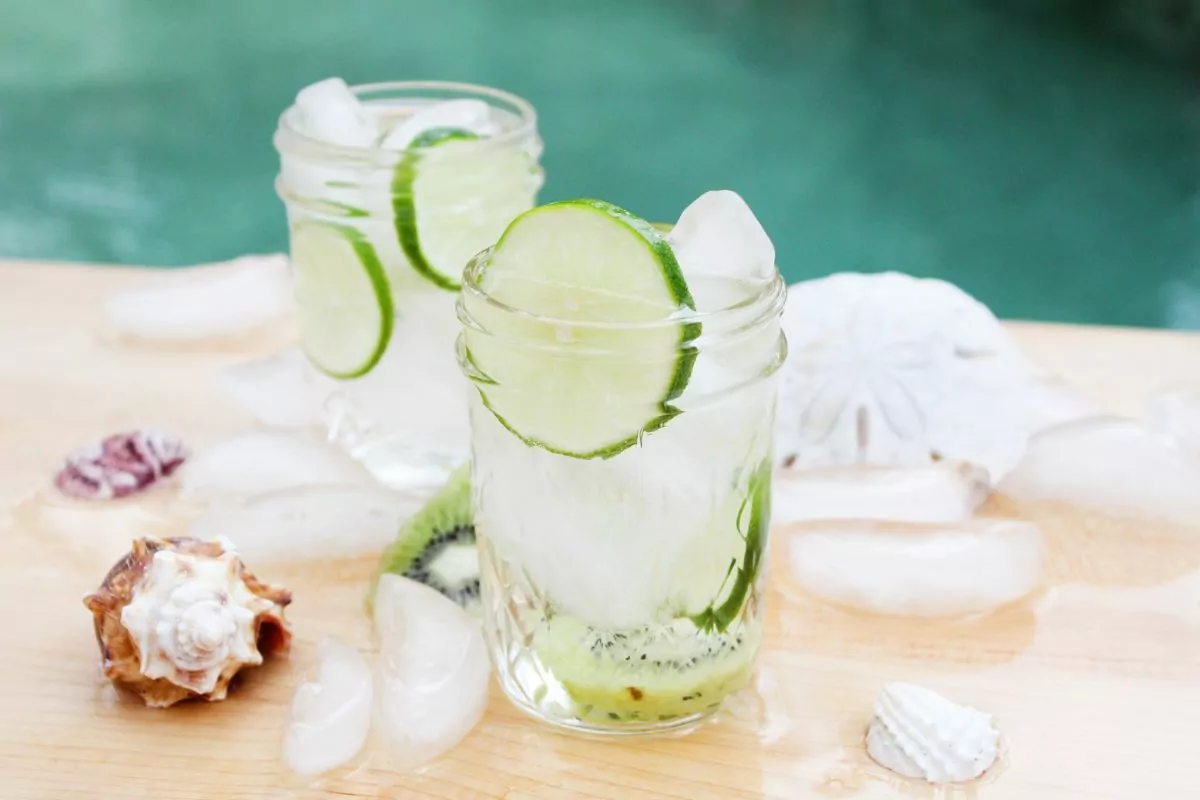 water in small mason jars with fresh lime slices.