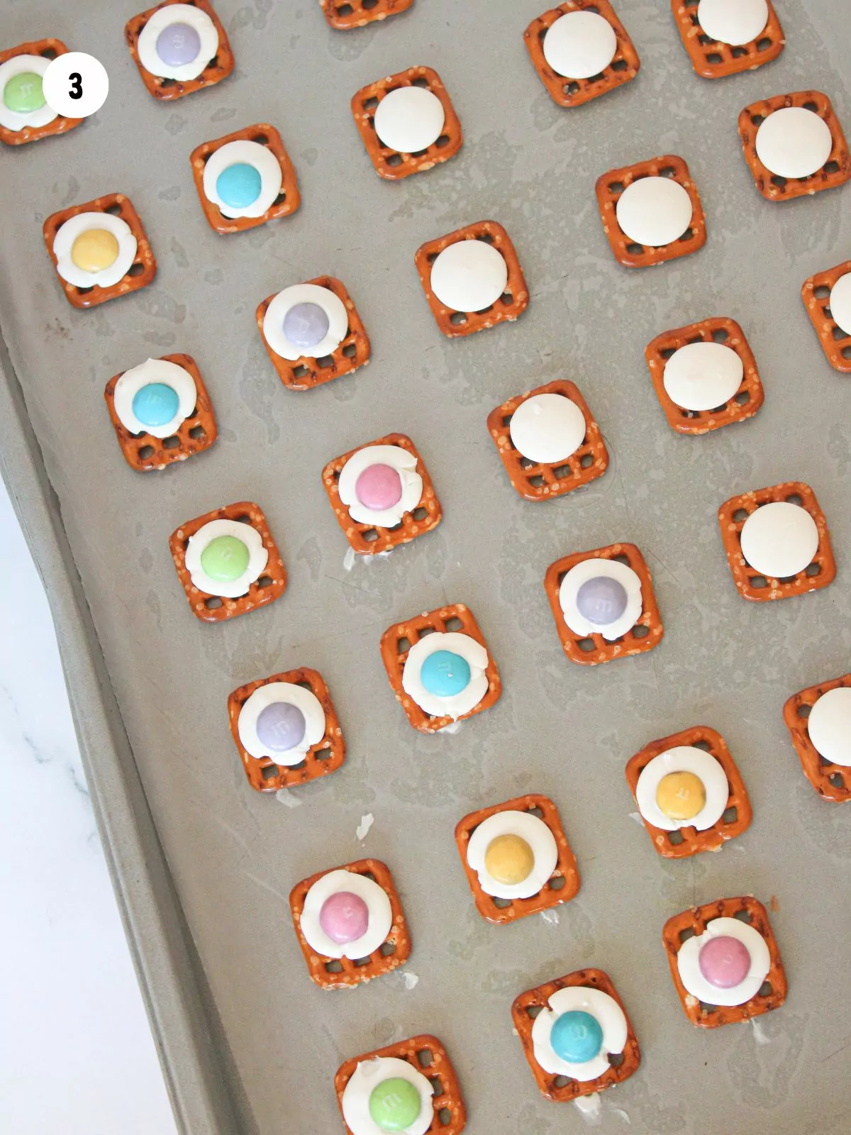 waffle pretzels with white candy melts and pastel candy M&Ms.