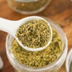 white teaspoon with dry seasoning blend.