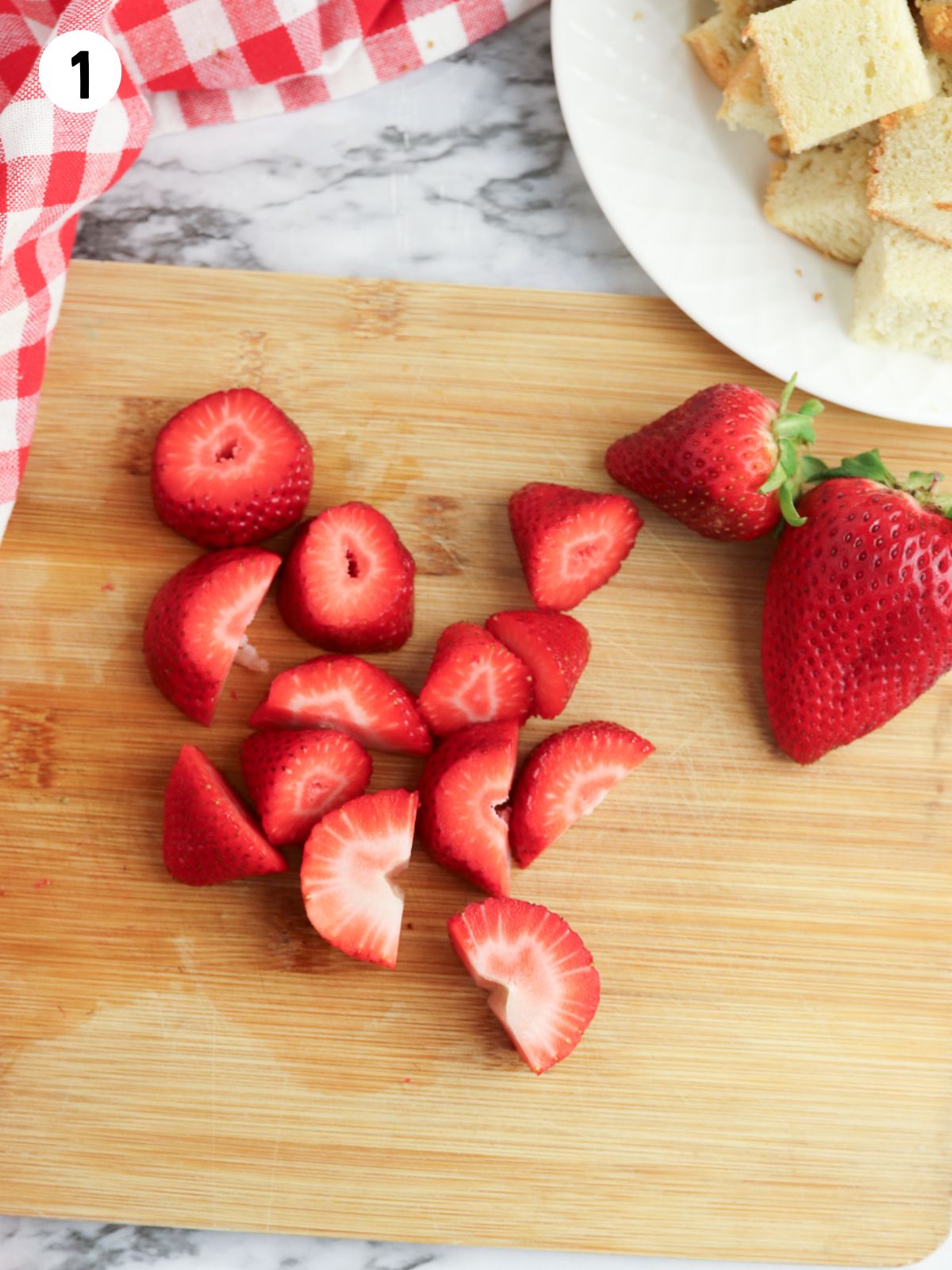 sliced strawberries on cutting board.