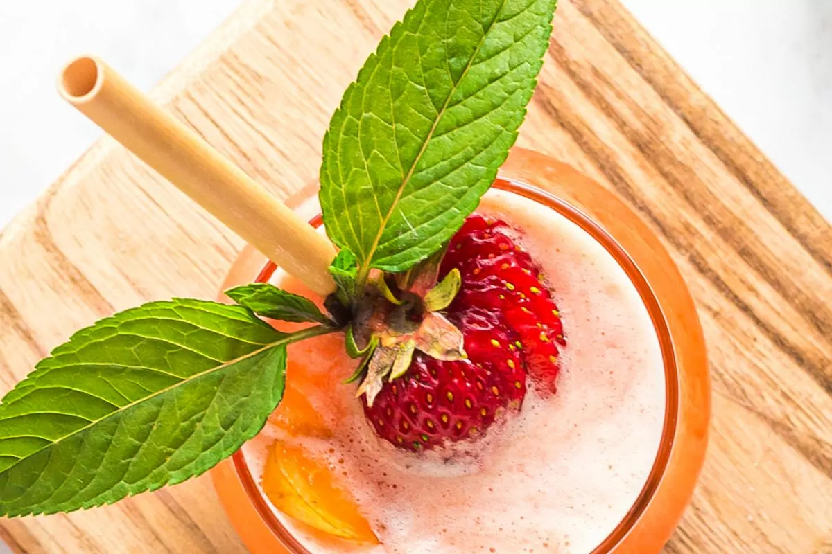 glass of strawberry peach water with fresh mint.