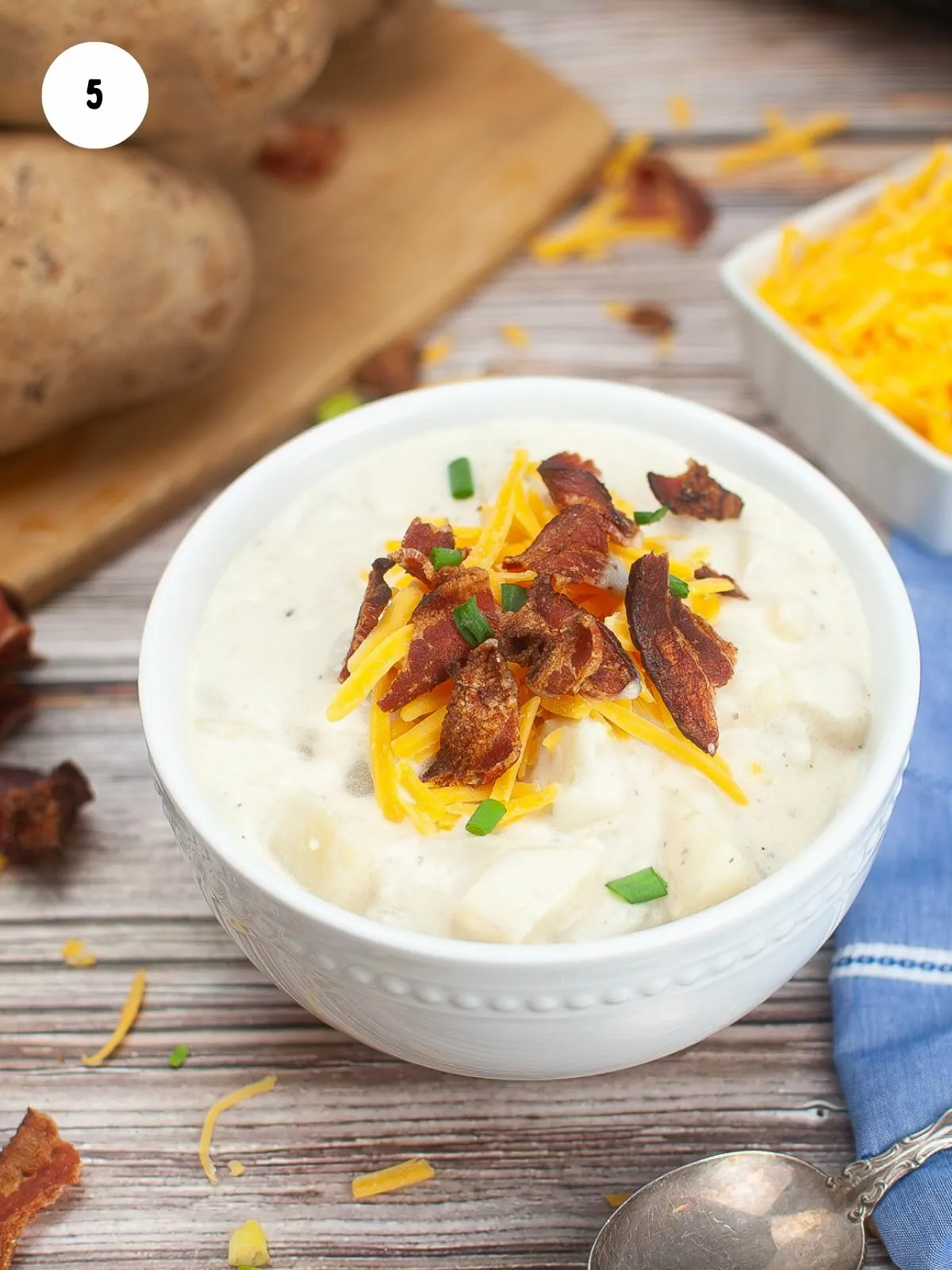 Top with shredded cheese, bacon, and chives